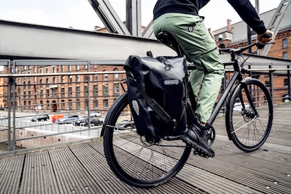 Sacoche vélo Ortlieb Back-Roller 20L montée sur un vélo de ville traversant un pont à Lyon