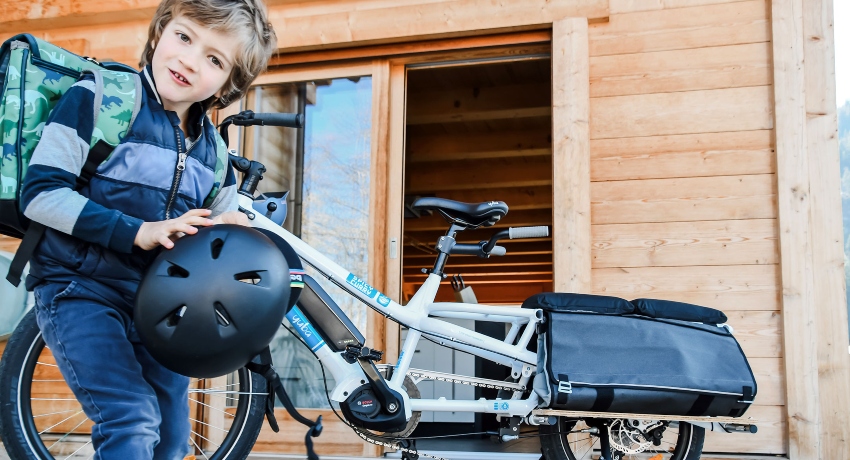 Enfant prêt à aller à l'école à vélo cargo