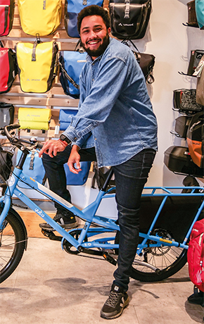 Alexandre chef d'équipe du magasin Cyclable Champagne sur un vélo longtail.